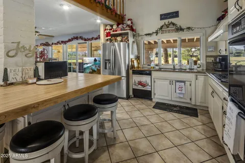 a kitchen with granite countertop a sink appliances cabinets and counter space