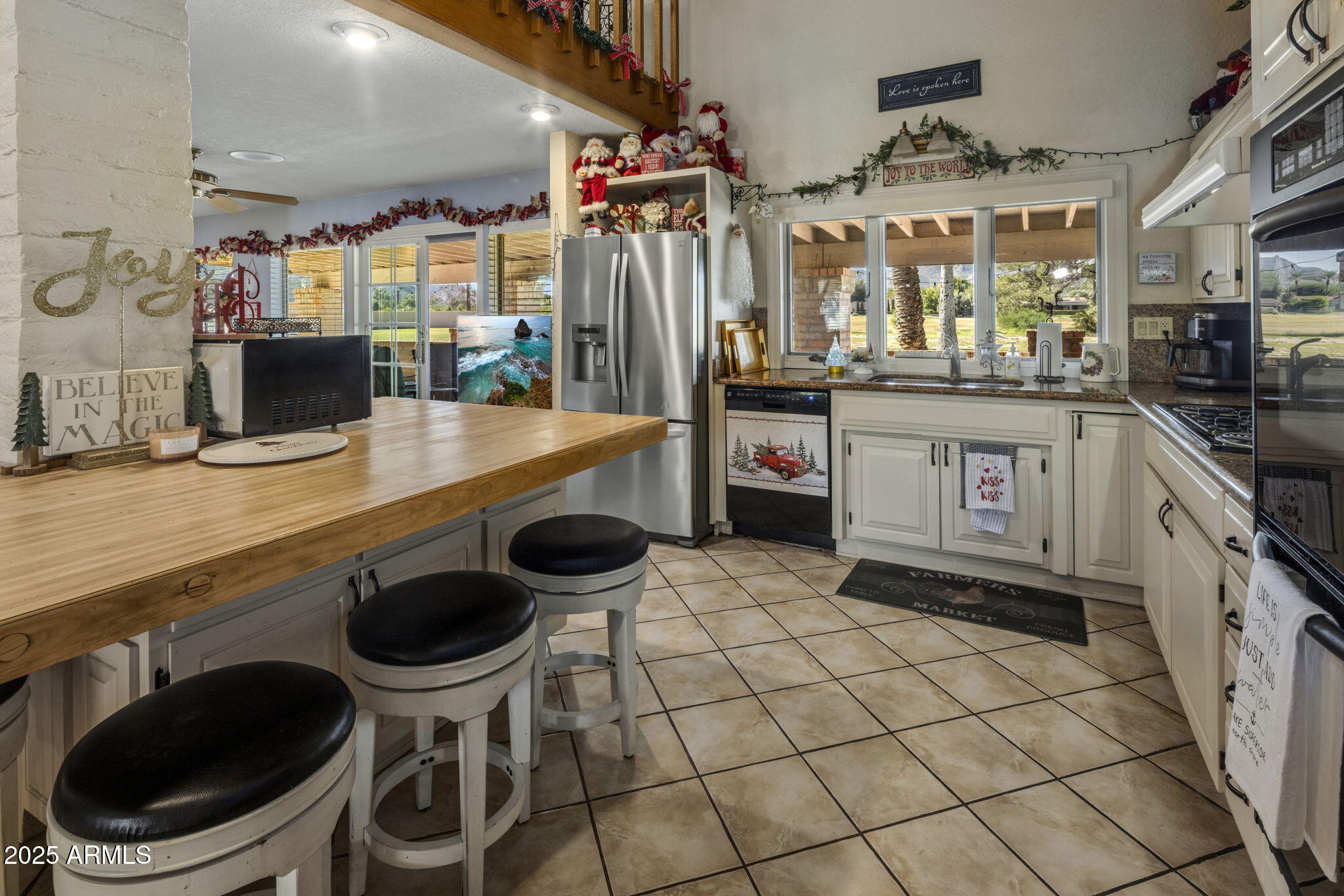 5555 East Turquoise Avenue Paradise Valley, AZ 85253 - Photo 9 of 36 a kitchen with stainless steel appliances kitchen island granite countertop a sink and a stove
