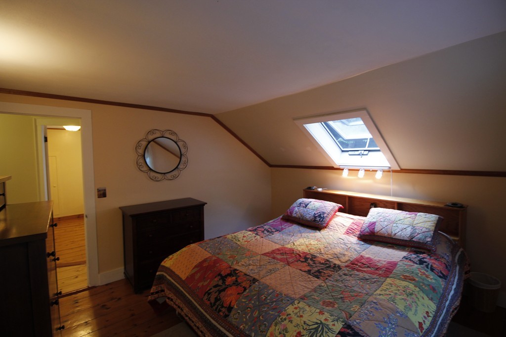 10 Judd Road Heath, MA 01339 - Photo 20 of 26 a bedroom with a bed and a chandelier