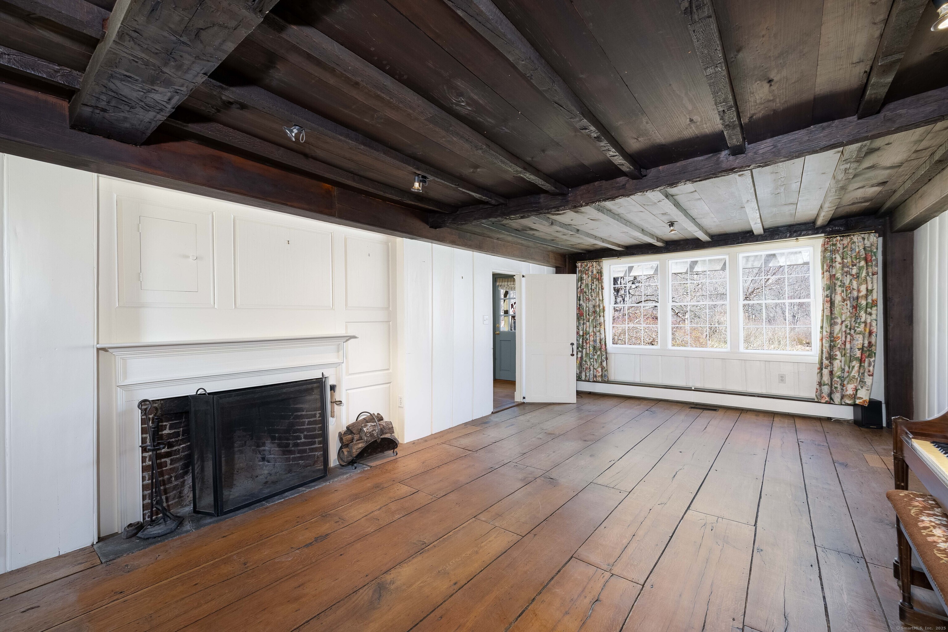 180 Green Hill Road Killingworth, CT 06419 - Photo 12 of 39 a view of empty room with wooden floor and fireplace