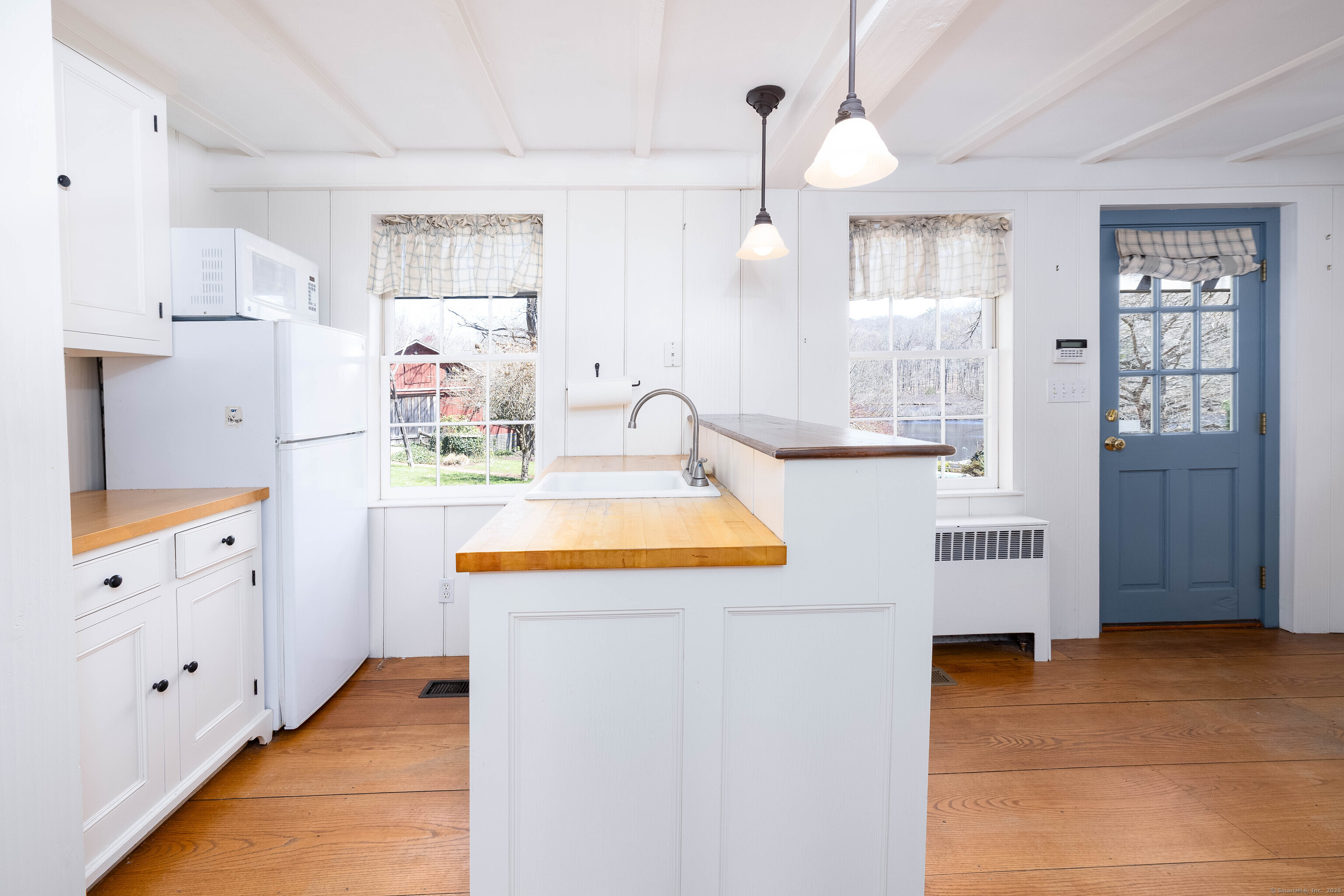 180 Green Hill Road Killingworth, CT 06419 - Photo 15 of 39 a kitchen that has a lot of cabinets in it and wooden floors