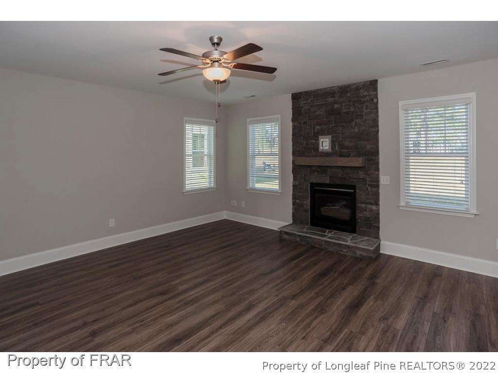 471 Kerr Lake Road Aberdeen, NC 28315 - Photo 8 of 32 a view of an empty room with wooden floor and a window