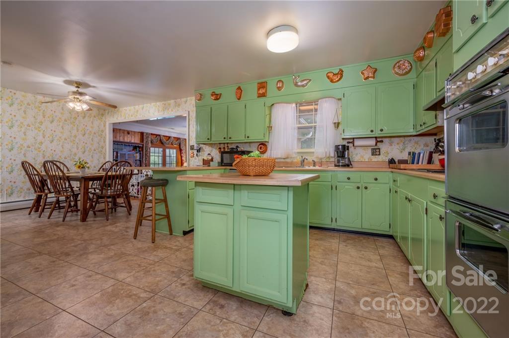 761 Poors Ford Road Rutherfordton, NC 28139 - Photo 15 of 48 a kitchen with lots of wooden cabinets appliances and furniture
