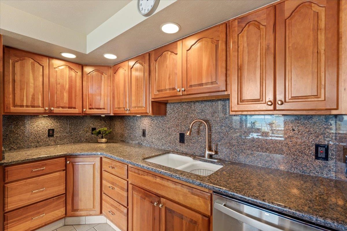 1993 South Kihei Road, Unit 601 Kihei, HI 96753 - Photo 13 of 45 a kitchen with granite countertop a sink a stove and cabinets
