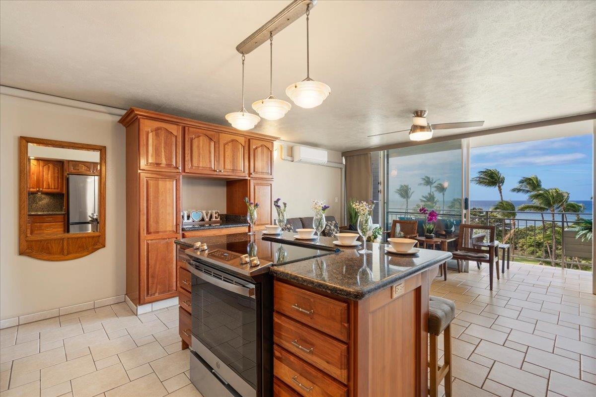 1993 South Kihei Road, Unit 601 Kihei, HI 96753 - Photo 15 of 45 a kitchen with stainless steel appliances granite countertop a stove and a sink