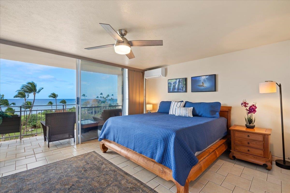 1993 South Kihei Road, Unit 601 Kihei, HI 96753 - Photo 2 of 45 a bedroom with a bed and a large window