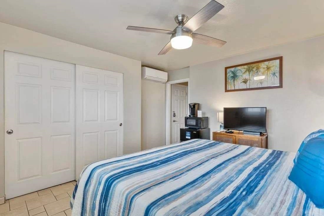 1993 South Kihei Road, Unit 601 Kihei, HI 96753 - Photo 38 of 45 a bedroom with a bed and a flat screen tv