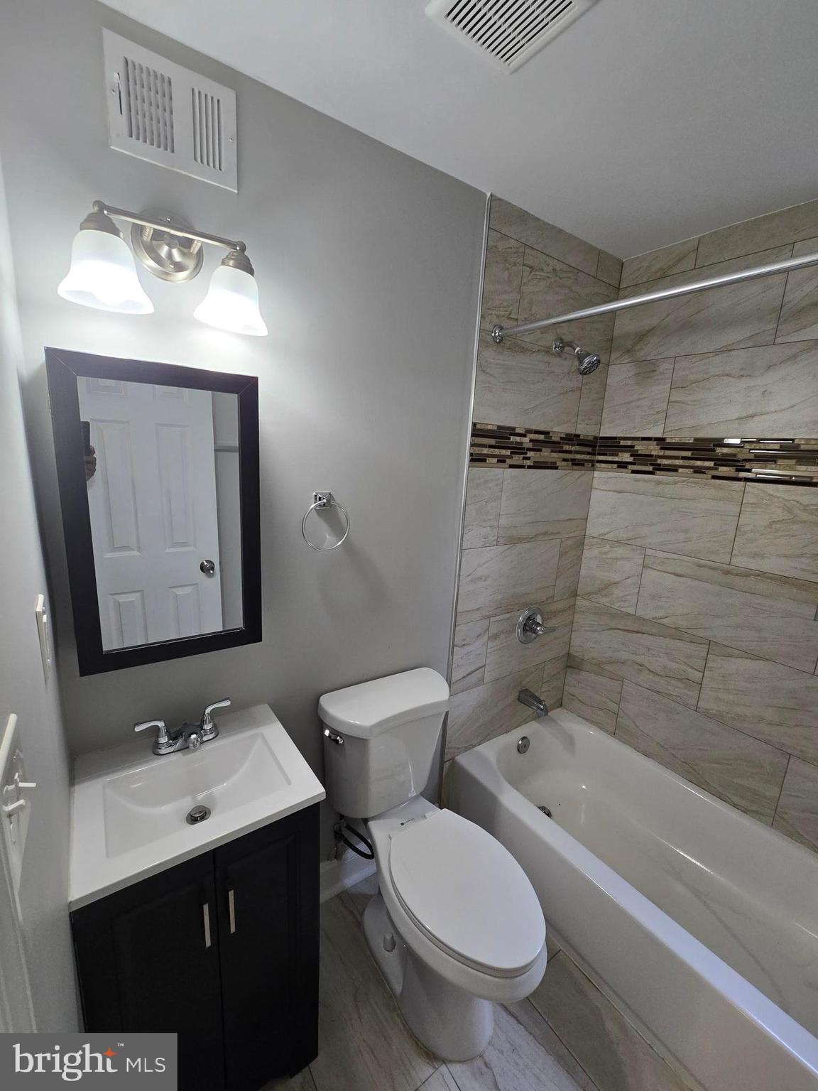 144 Chestnut Street Baltimore, MD 21222 - Photo 11 of 14 a bathroom with a toilet sink and mirror