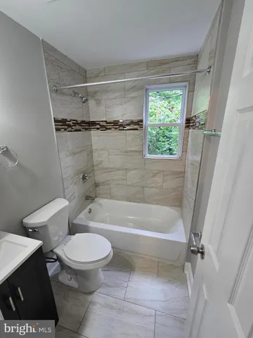 a bathroom with a bathtub toilet and shower
