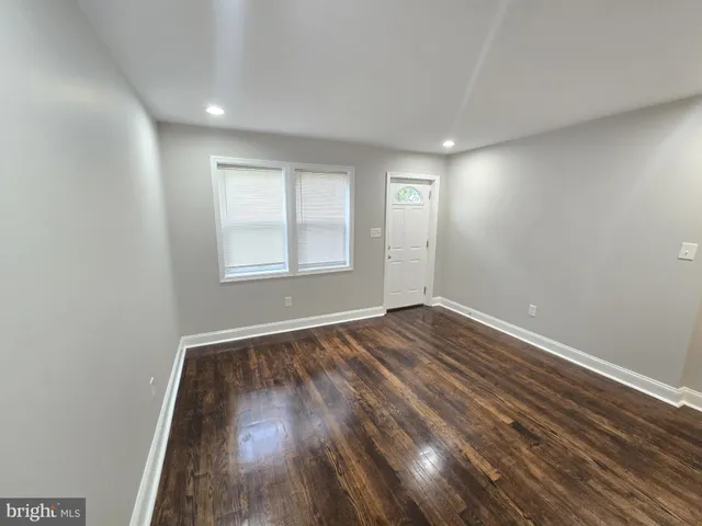 wooden floor in an empty room with window