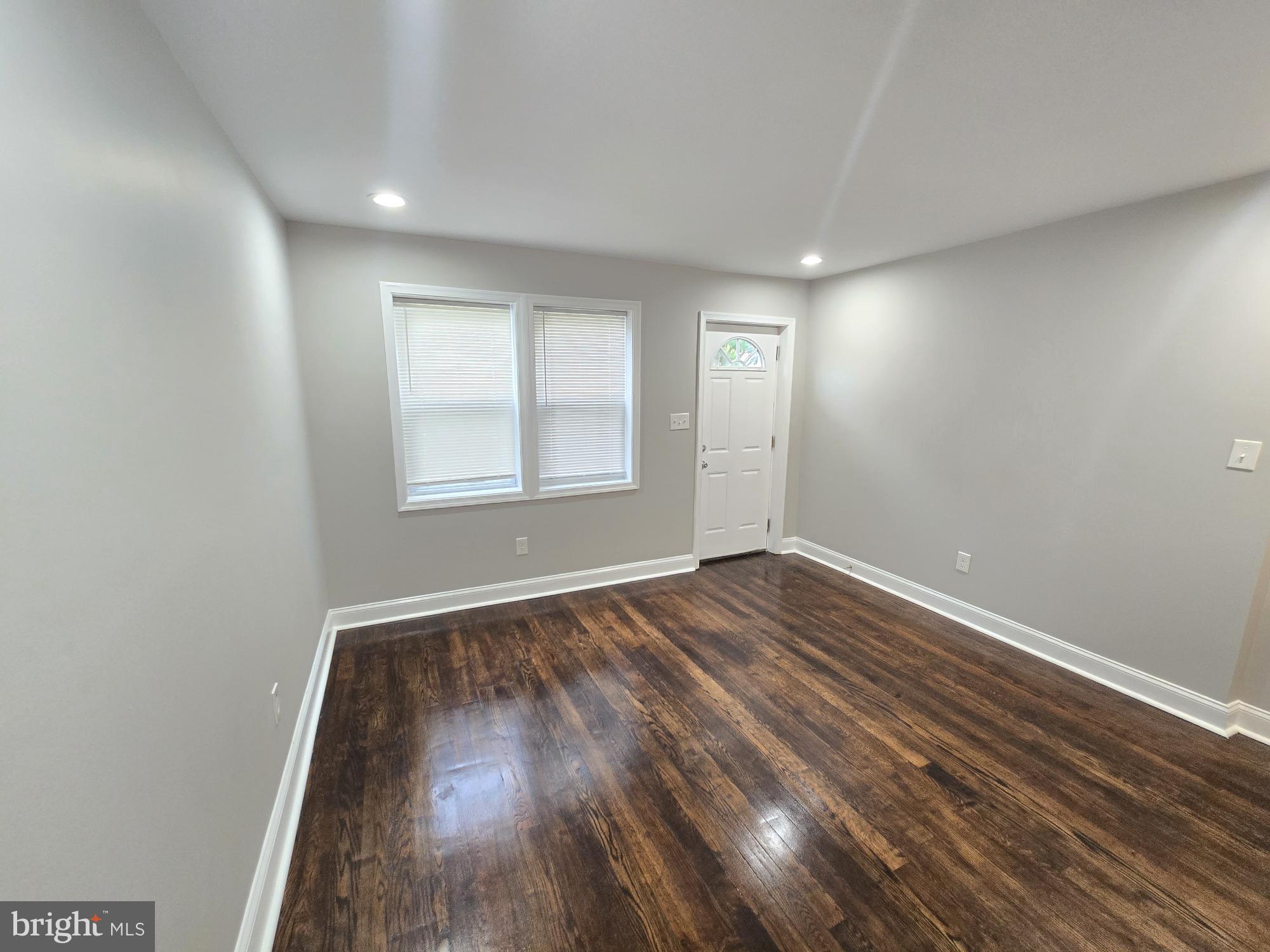 144 Chestnut Street Baltimore, MD 21222 - Photo 3 of 14 wooden floor in an empty room with window