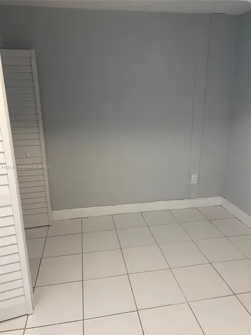 a view of an empty room and a window