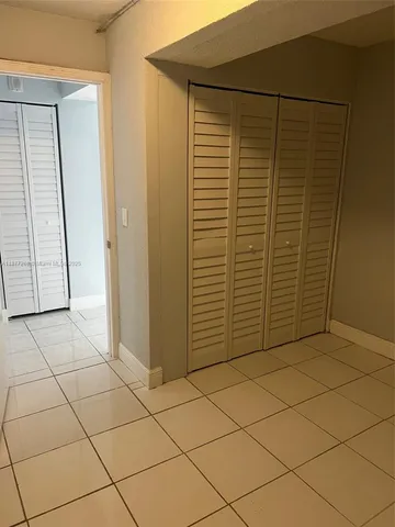 a kitchen with a sink a microwave and cabinets