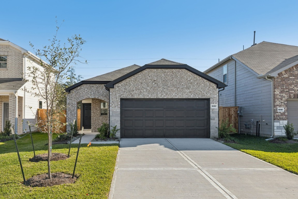 a front view of a house with a garden