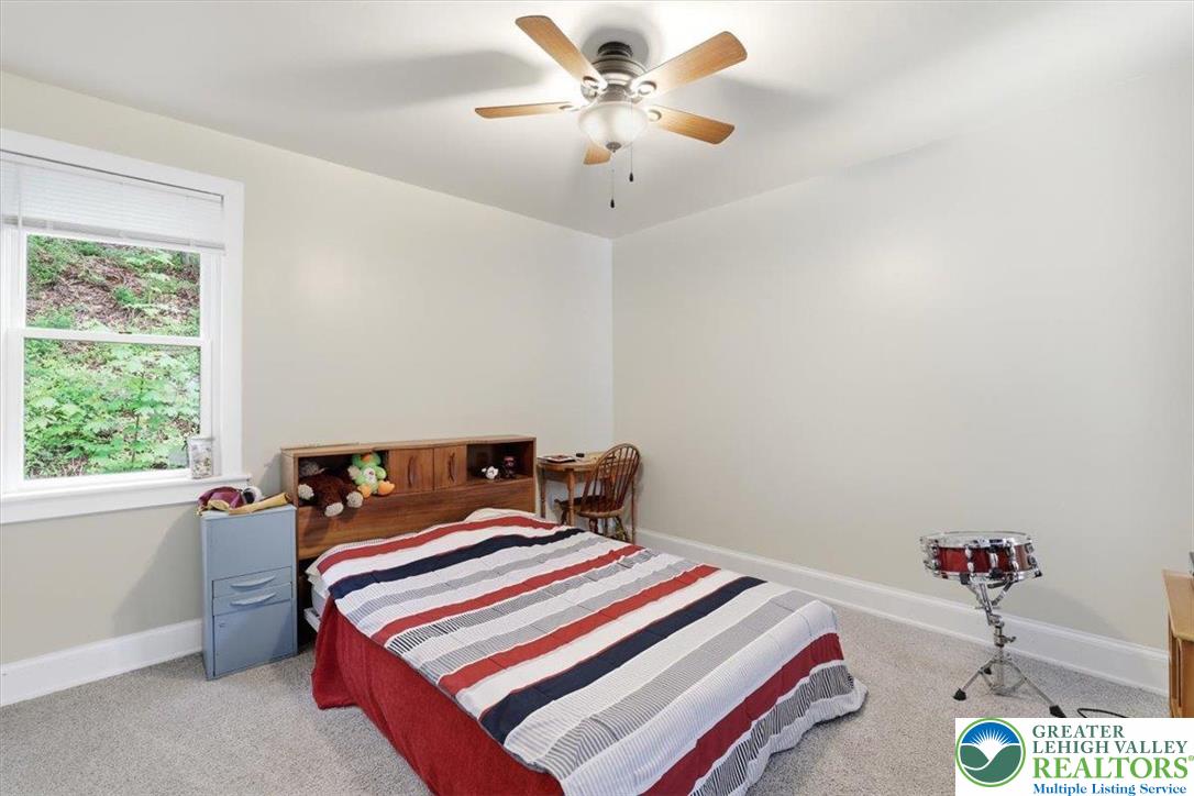 3585 Fairyland Road Lehighton, PA 18235 - Photo 43 of 57 a bedroom with a bed and a chandelier fan
