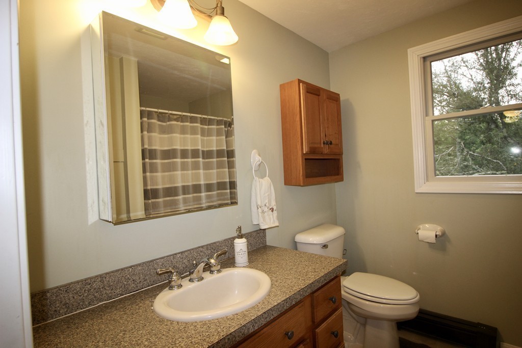 28 Hillside Road Rochester, MA 02770 - Photo 17 of 20 a bathroom with a granite countertop toilet a sink and a mirror