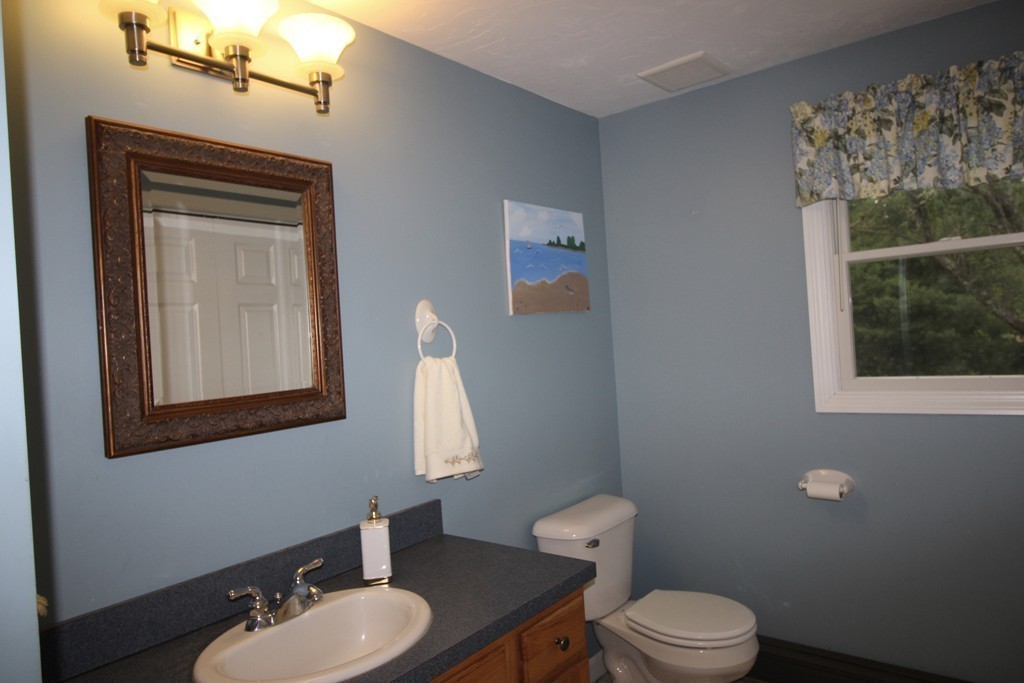28 Hillside Road Rochester, MA 02770 - Photo 9 of 20 a bathroom with a toilet a sink and mirror