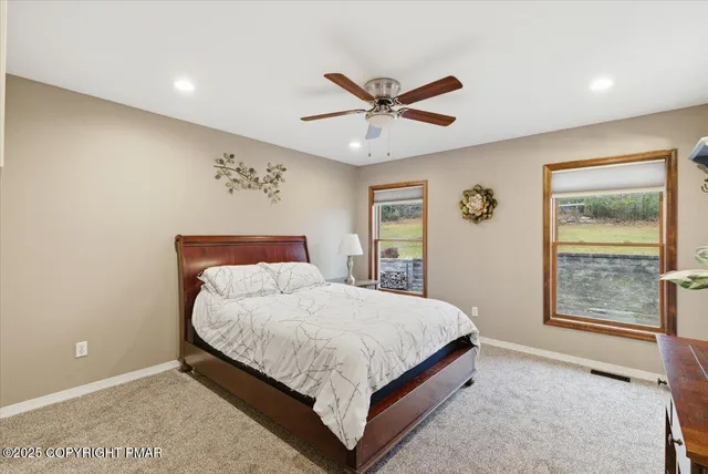 a bedroom with a large bed and a window
