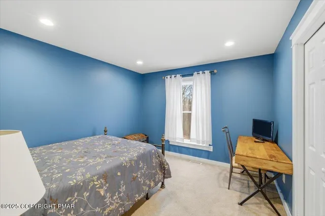 a bedroom with a bed and chair