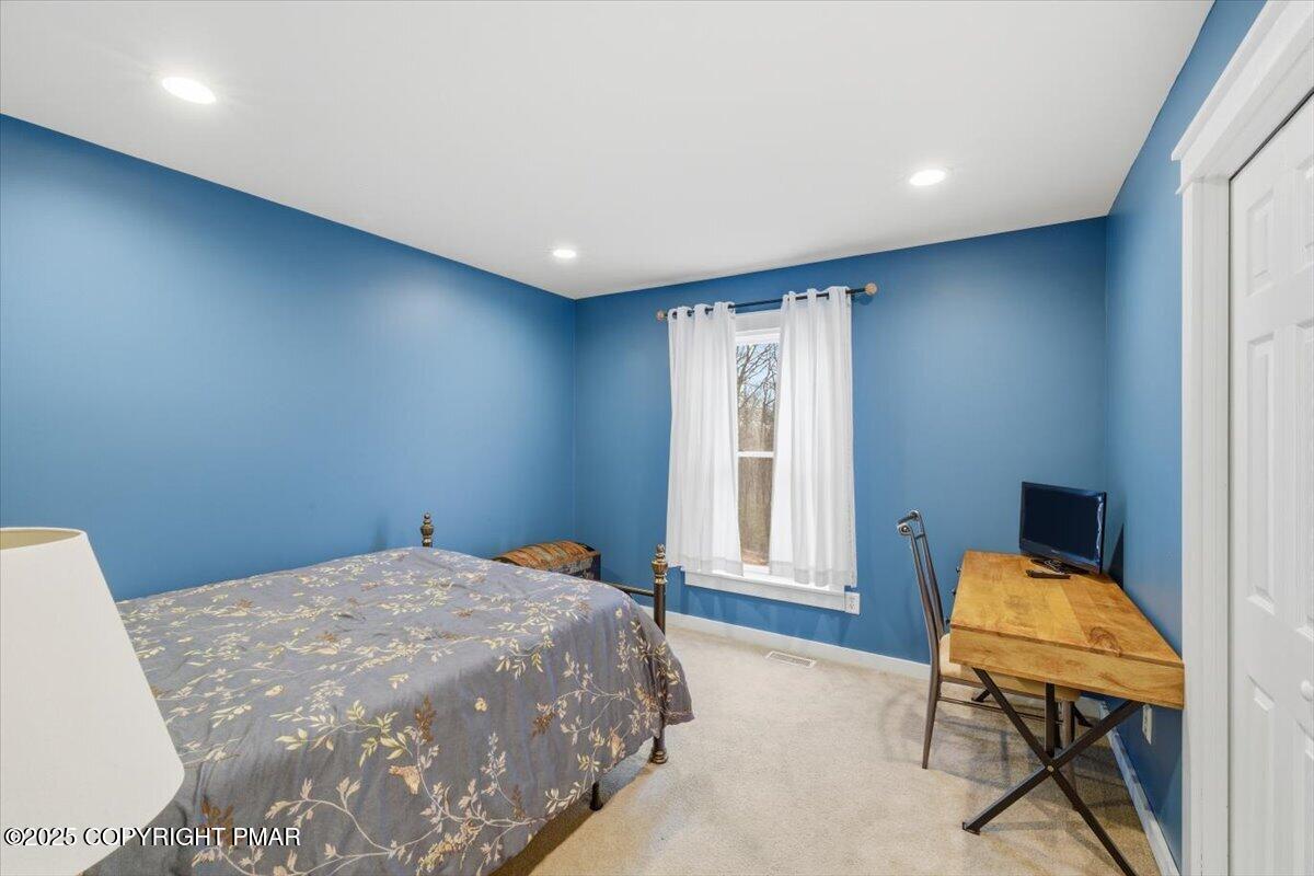 126 Snyder Lane Scotrun, PA 18355 - Photo 16 of 22 a bedroom with a bed and chair