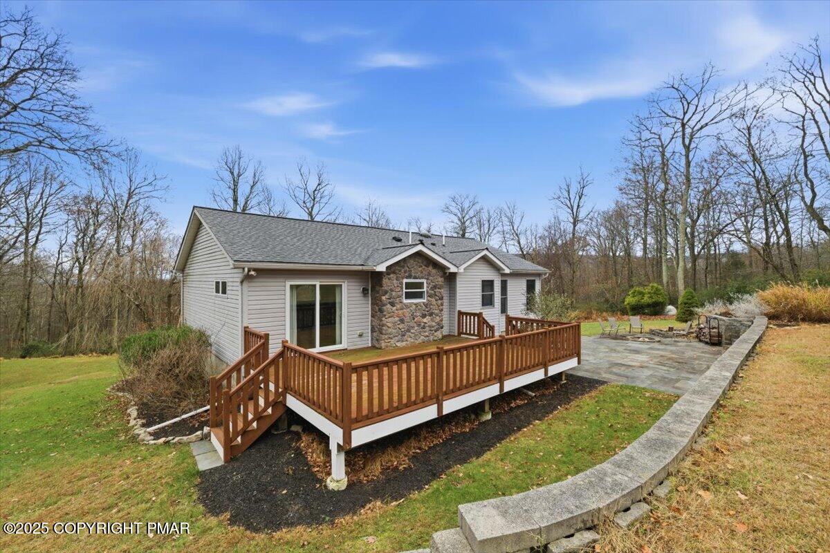 126 Snyder Lane Scotrun, PA 18355 - Photo 22 of 22 a view of a house with a wooden deck and a yard