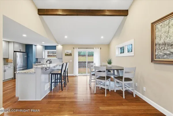 a view of a dining room with furniture window and wooden floor