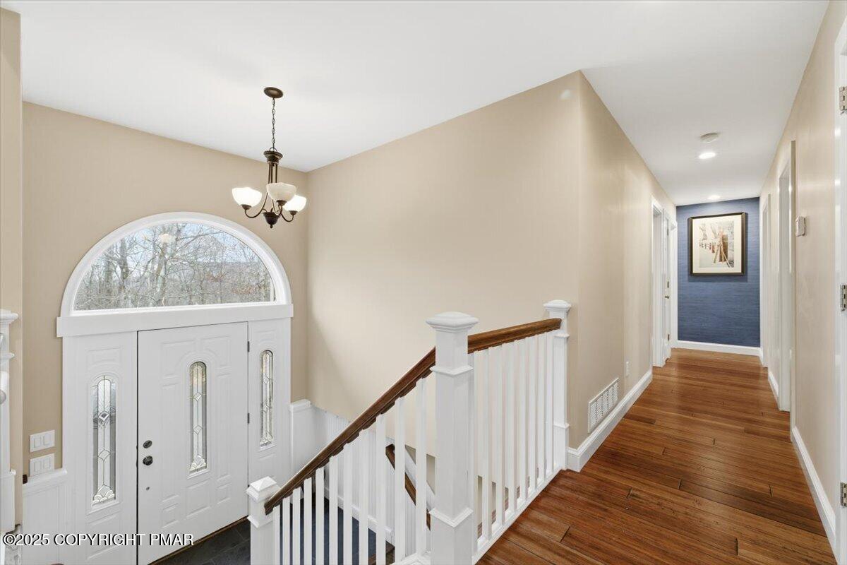 126 Snyder Lane Scotrun, PA 18355 - Photo 10 of 22 a view of a hallway with wooden floor and staircase