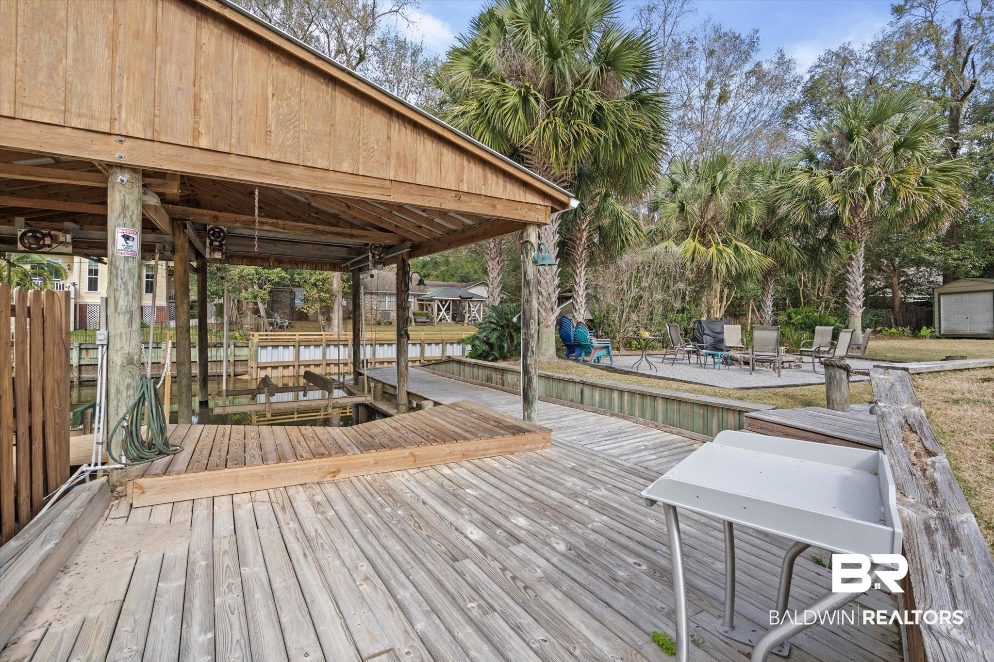 3720 Rabbit Creek Court Theodore, AL 36582 - Photo 29 of 47 Dock featuring boat lift, a deck, and a patio