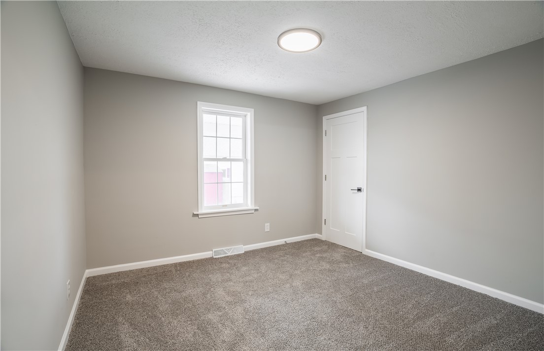 8240 Looney Road Piqua, OH 45356 - Photo 16 of 49 This inviting bedroom features soft carpet and a window offering natural light.
