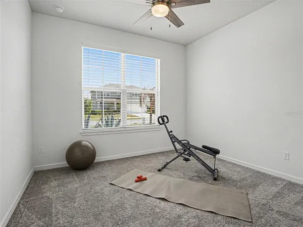 a room with gym equipment and a window