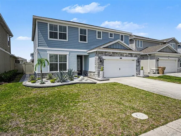 a view of a house with swimming pool and a yard