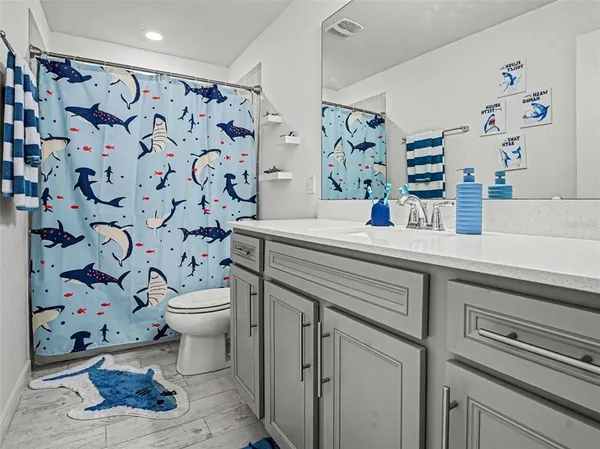 a bathroom with a sink toilet and shower