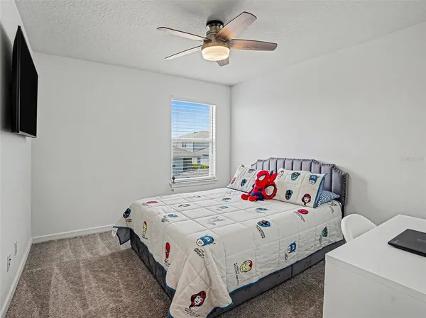 a bedroom with a bed and a tv in it