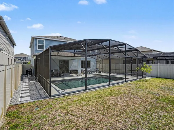 a view of a house with wooden fence