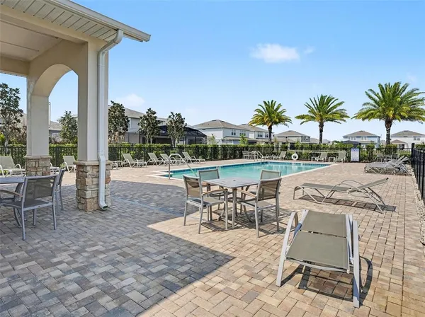 a view of a patio with a dining table and chairs
