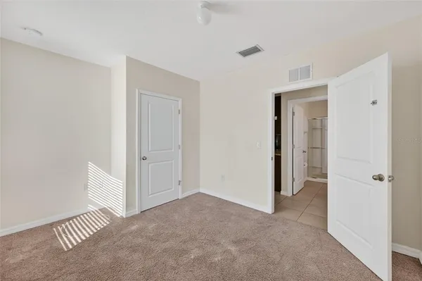a view of a livingroom with a walk in closet and wooden floor