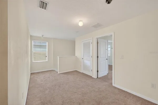 a view of an empty room and a window