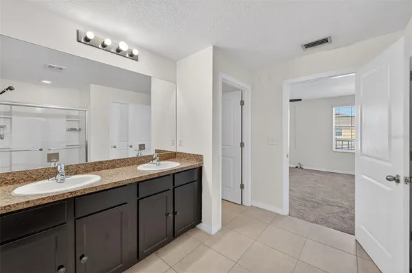 a spacious bathroom with a granite countertop sink a mirror and a