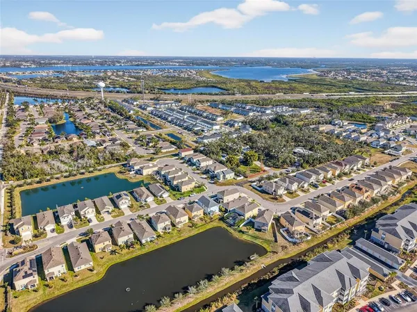 an aerial view of residential building and lake