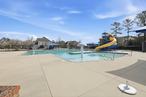 a view of a house with swimming pool and sitting area