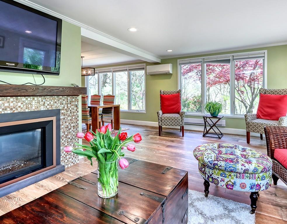 11 Juniper Ridge Road Lincoln, MA 01773 - Photo 11 of 36 a living room with furniture a fireplace and a floor to ceiling window