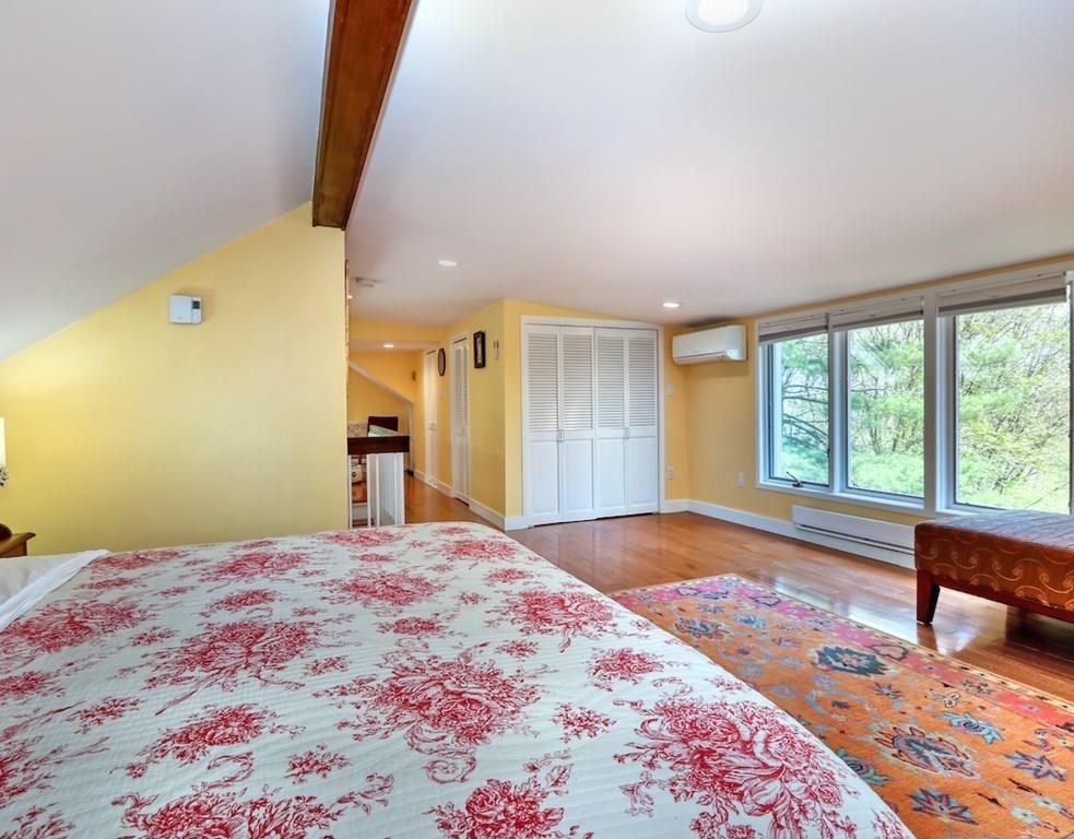 11 Juniper Ridge Road Lincoln, MA 01773 - Photo 15 of 36 a large bedroom with a bed and wooden floor