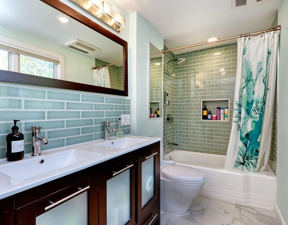 11 Juniper Ridge Road Lincoln, MA 01773 - Photo 18 of 36 a bathroom with a sink a toilet a mirror and shower
