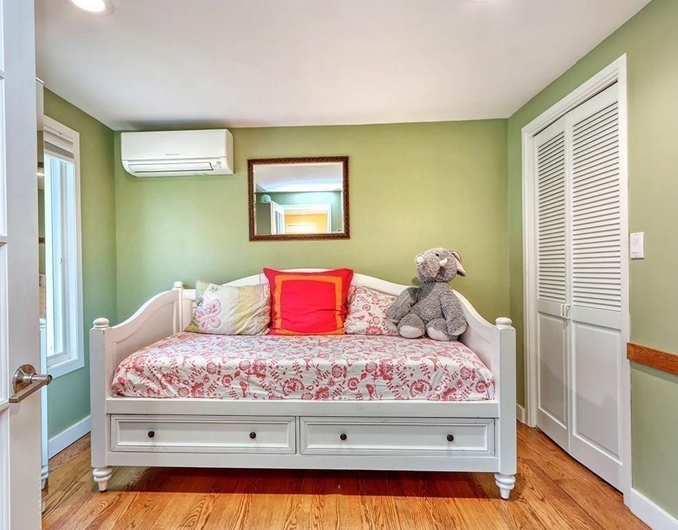 11 Juniper Ridge Road Lincoln, MA 01773 - Photo 21 of 36 a bedroom with a bed and a painting on the wall