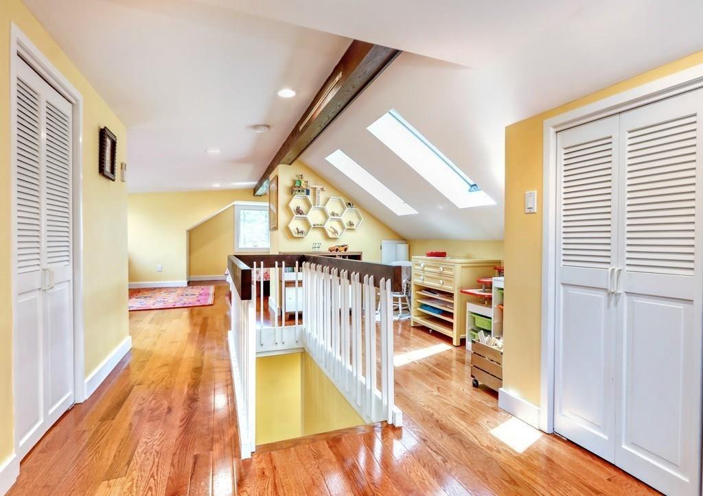 11 Juniper Ridge Road Lincoln, MA 01773 - Photo 25 of 36 a view of a hallway with wooden floor and staircase