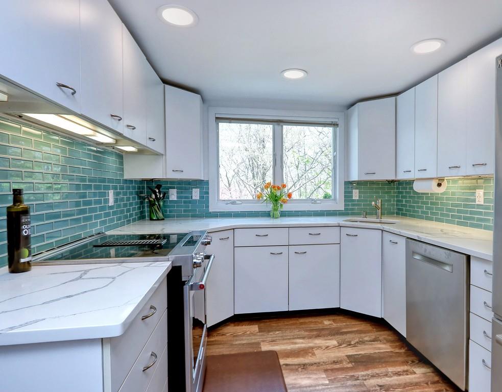 11 Juniper Ridge Road Lincoln, MA 01773 - Photo 3 of 36 a kitchen that has a sink and a stove in it