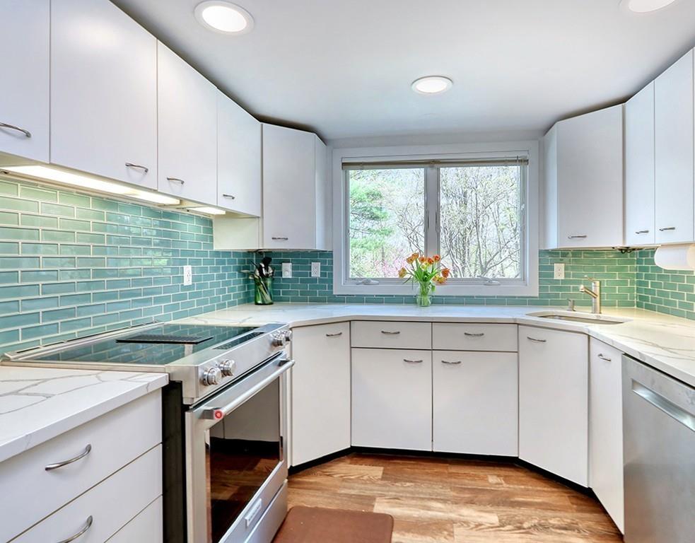 11 Juniper Ridge Road Lincoln, MA 01773 - Photo 8 of 36 a kitchen with stainless steel appliances granite countertop a sink a stove and cabinets