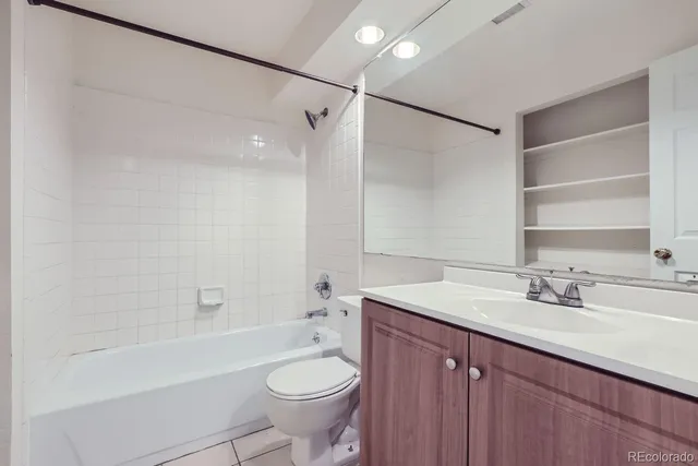 a bathroom with a sink toilet a mirror and shower