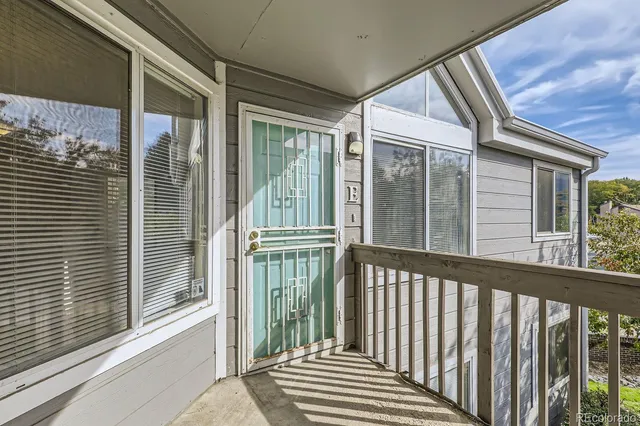 a view of a balcony with a floor to ceiling window