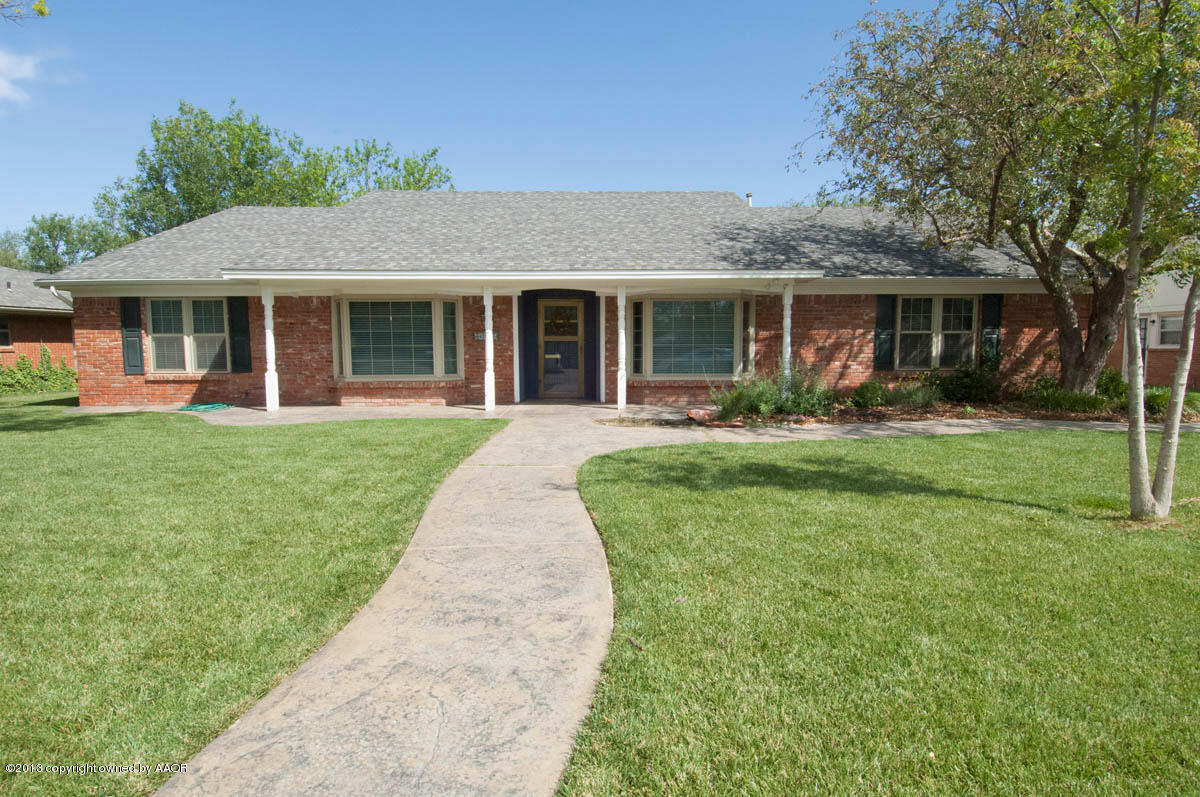 6206 Calumet Road Amarillo, TX 79106 - Photo 1 of 47 a front view of a house with a yard and potted plants